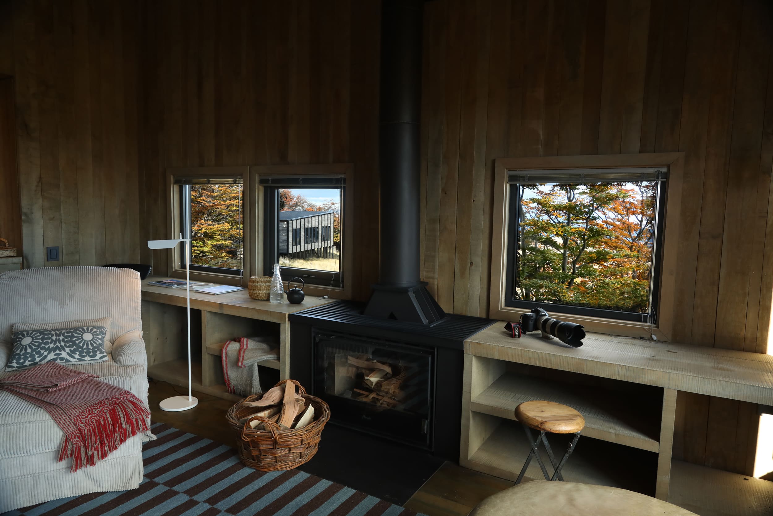 Interior of a private villa at Awasi Patagonia in Torres del Paine, Chile, featuring elegant, sustainable design, warm wooden accents, and large windows that frame the rugged Patagonian landscape outside, highlighting the lodge’s luxury and immersion in nature.