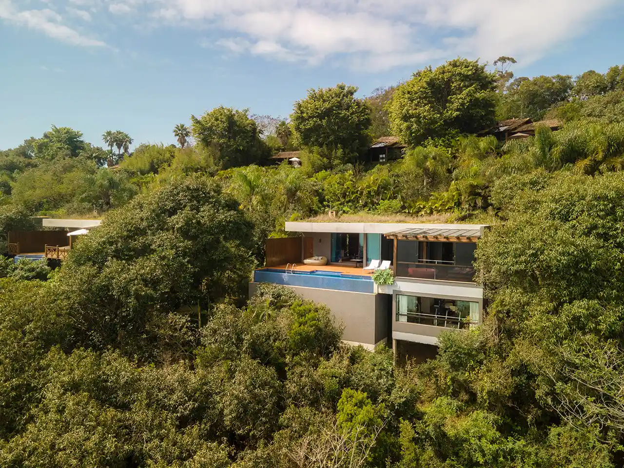 Modern villas with green roofs and private infinity pools integrated into the lush rainforest at Awasi Iguazu