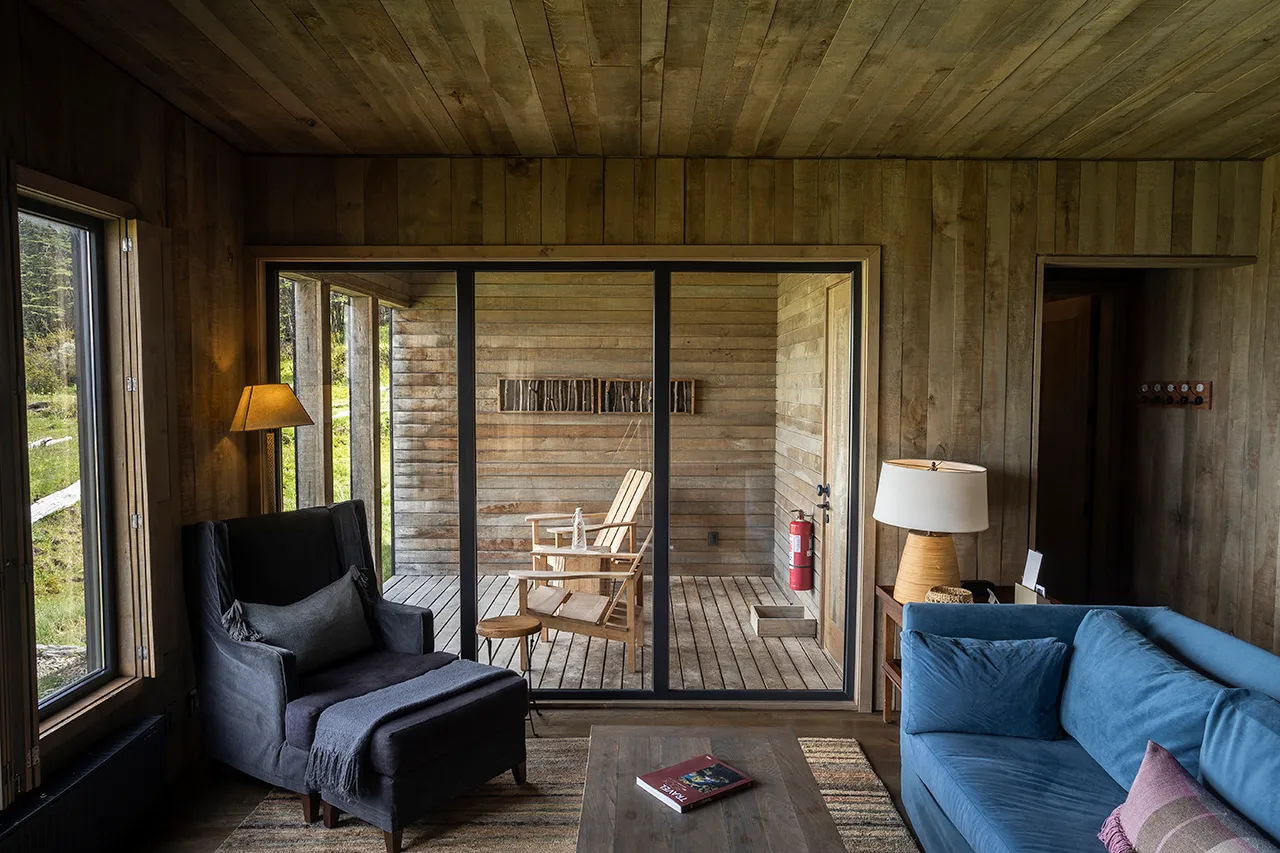 Cozy wooden living room with lounge seating and terrace view