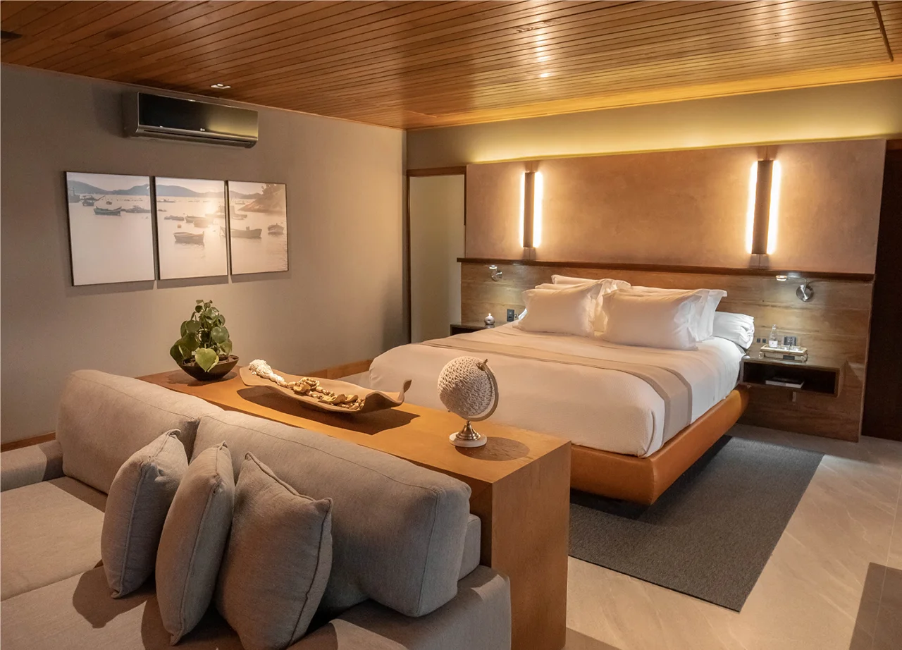 Elegant bedroom with king bed warm lighting wooden details and cozy seating area creating a relaxing