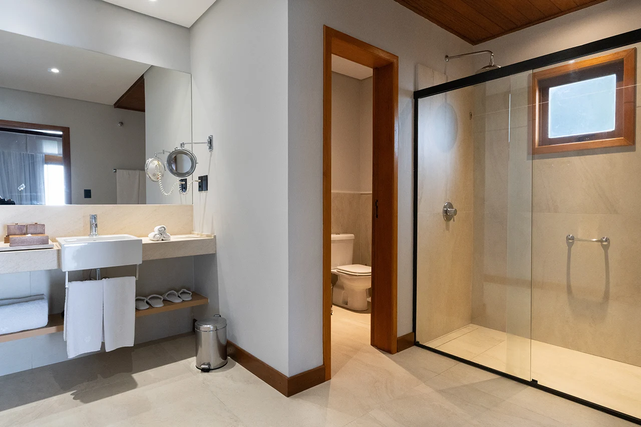Modern bathroom with walk in glass shower vanity sink and minimalist design with natural light